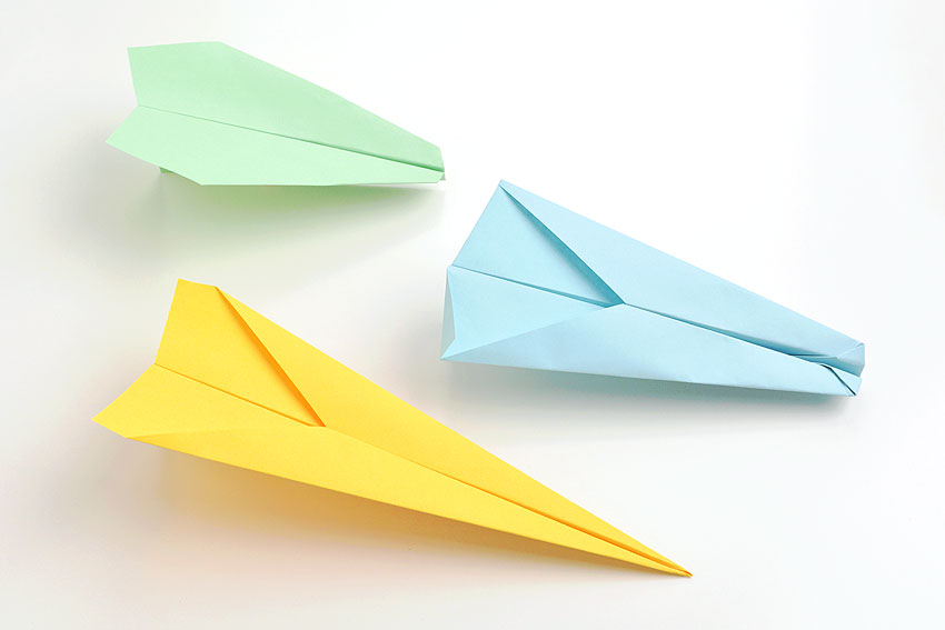 a picture of three paper airplanes all built and designed differently. 