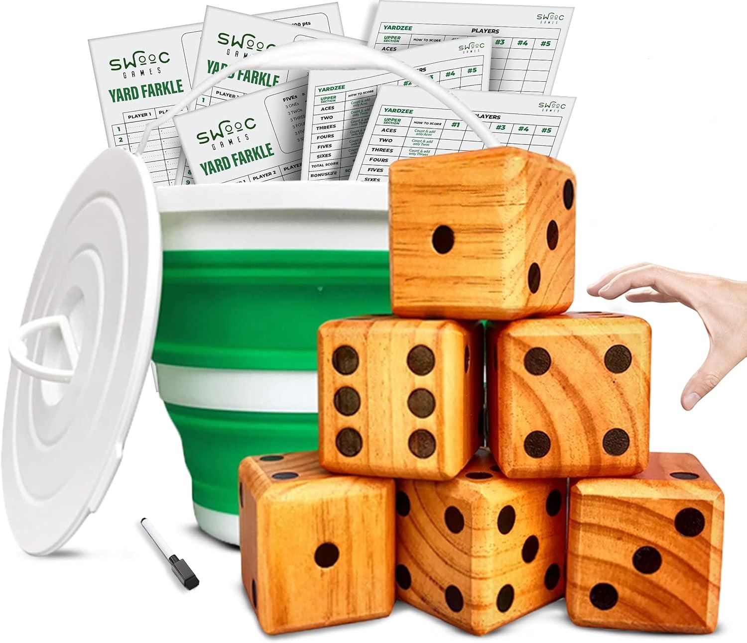 green and white bucket holds score cards; a hand reaches towards a stack of 6 wooden dice