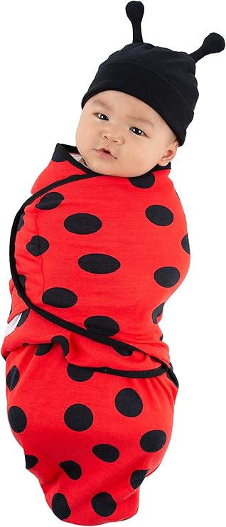 image of infant swaddled in red and black ladybug outift