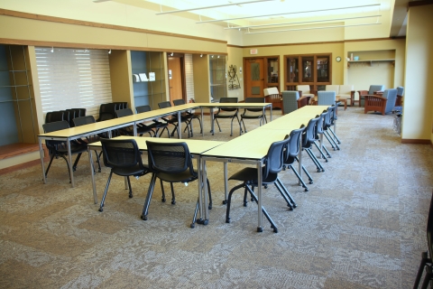 Heritage room with table arranged in rectangle and chairs around the outside