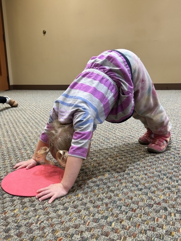 Child doing downward dog