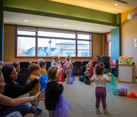 image of children dancing with scarves