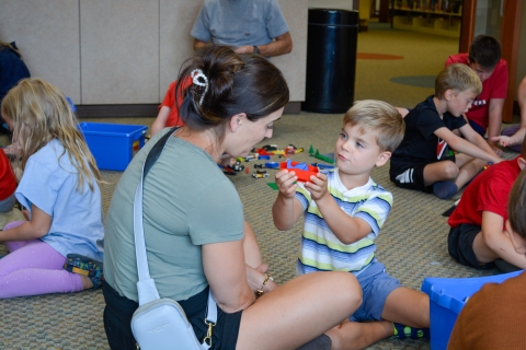 Parent building legos with child