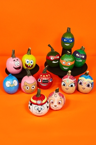 Stack of pumpkins painted like various children's tv show characters