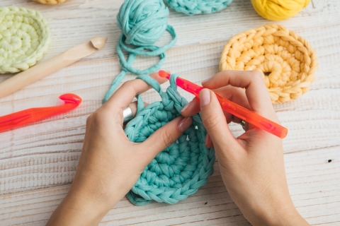 hands with crochet needles crocheting