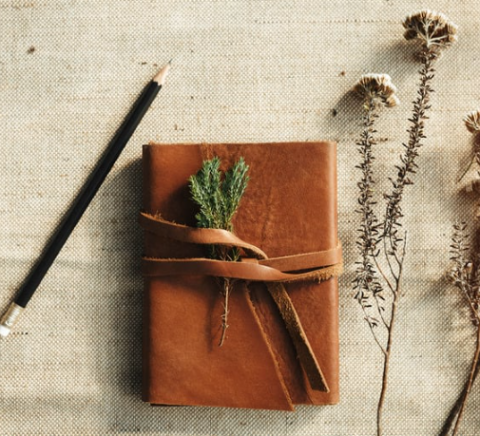 image of leather journal, pencil, and lavender sprigs