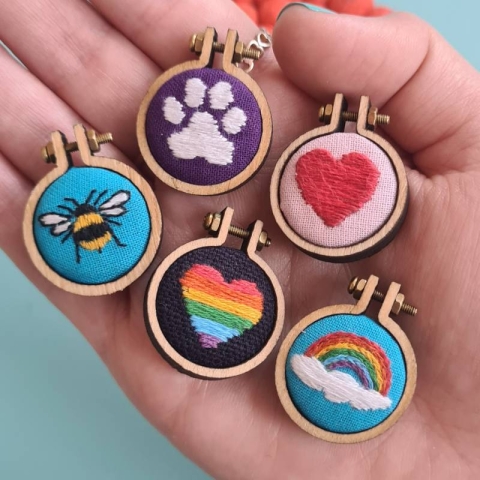 Mini bee, dog paw, rainbow, and heart embroidery hoop art