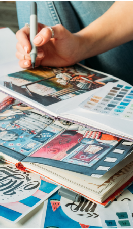 image of a person's hand writing in a collage style journal