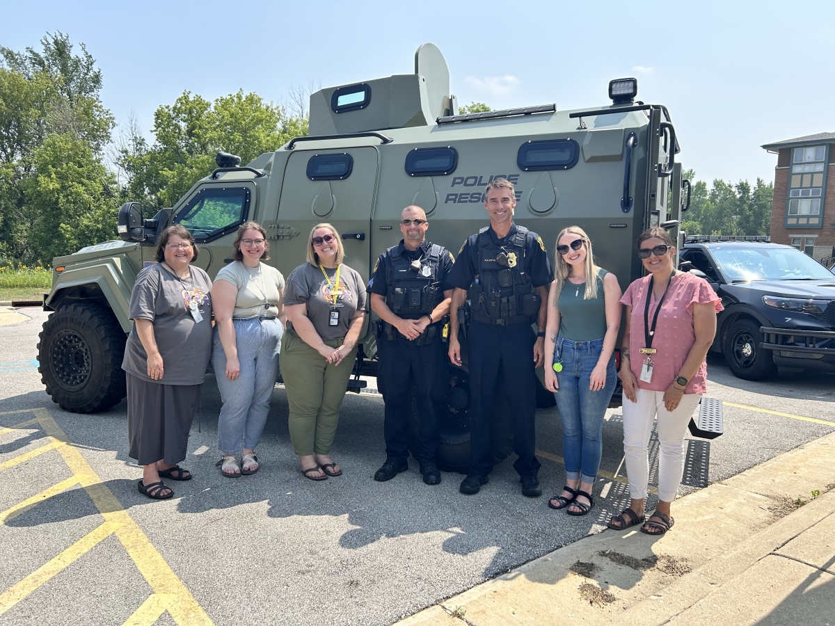 New Berlin Police and Librarians in front of SWAT vehicle at summer party